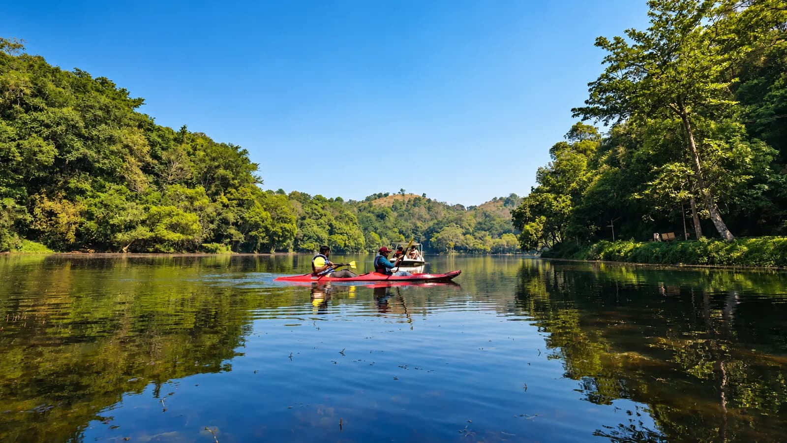 Kayakers on forest-lined Pookode Lake