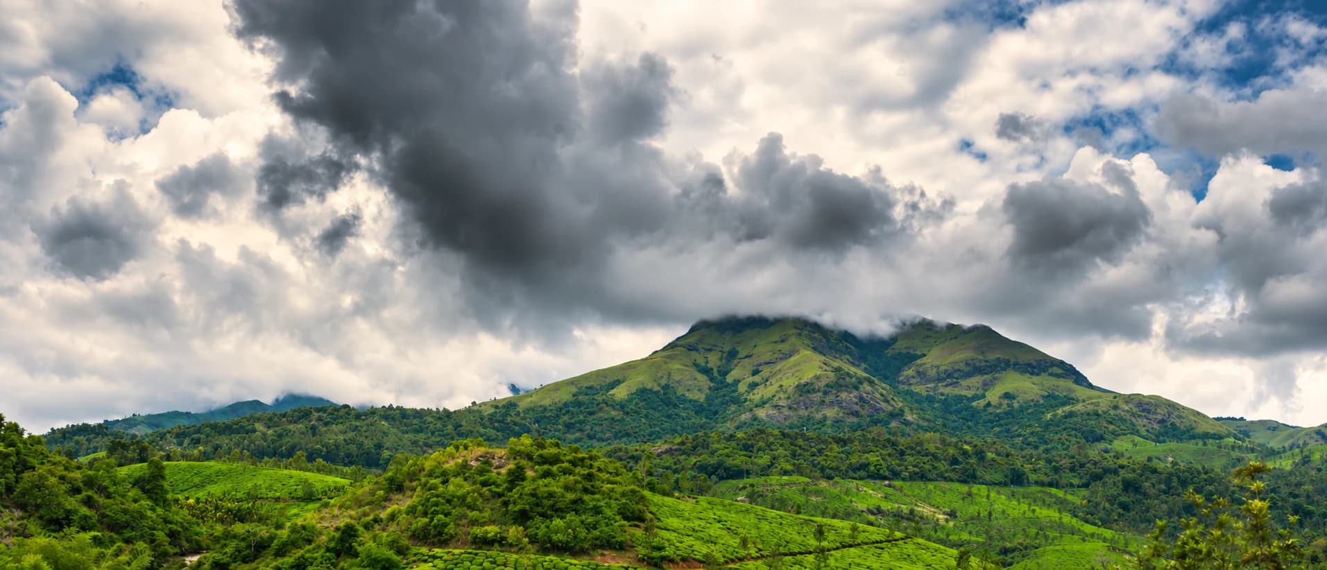 Chembra hills beneath clouds, cinematic colour edit of a real destination photograph